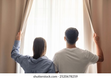 Young man and woman looking out window concept of travel or family relationships. - Powered by Shutterstock