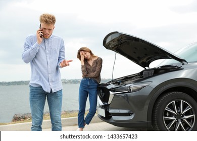 Young man and woman near broken car outdoors - Powered by Shutterstock