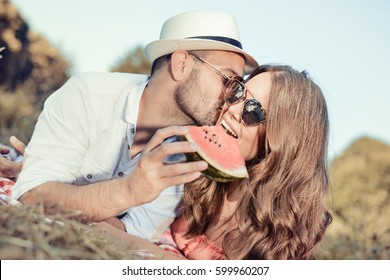 Young man and woman on picnic in the park.