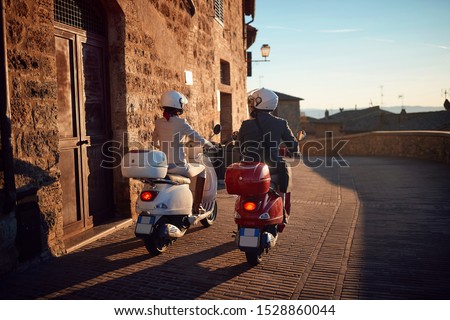 Young man and woman on Vespa Scooter. Bikers couple.