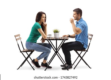 Young Man And Woman Sitting A Table And Drinking Coffee Isolated On White Background