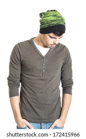 Young man with wool hat thinking with his hands in pockets isolated on a white background