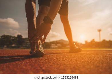 The young man wore all parts of his body to prepare for jogging on the running track around the football field. - Shutterstock ID 1533288491