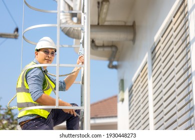 Young man worker or engineer climb ladder.