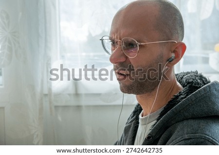young man working at computer, frustrated programmer specialist, tense moment during coding task, modern worker solving problems, Stressful moment in digital workflow, Emotional reaction home office