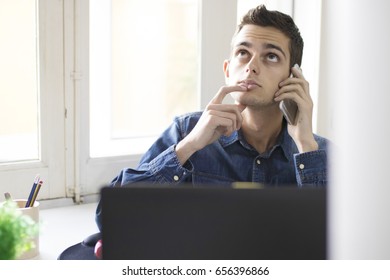 young man working with the computer laptop and mobile phone
