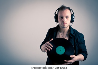 Young Man Working As Dj With Ear-phones And Disc.