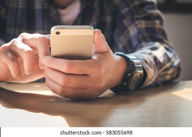 young man working from home using smart phone