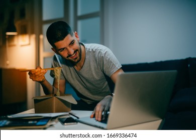 Young Man Working Late From His Home, Eating Chinese Food