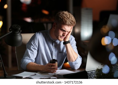 Young man working in office at night - Shutterstock ID 1437172136