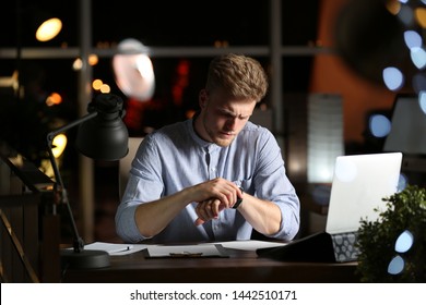 Young man working in office at night - Shutterstock ID 1442510171