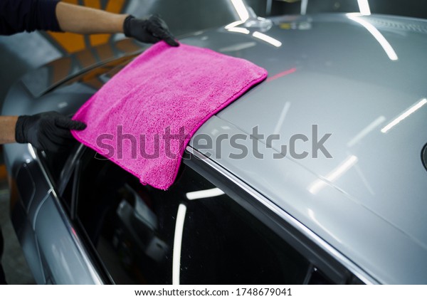 young man working on
dry cleaning. car detailing. polishing. car wash. oil change in the
car. car service
