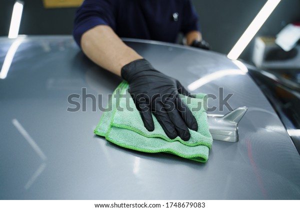young man working on\
dry cleaning. car detailing. polishing. car wash. oil change in the\
car. car service