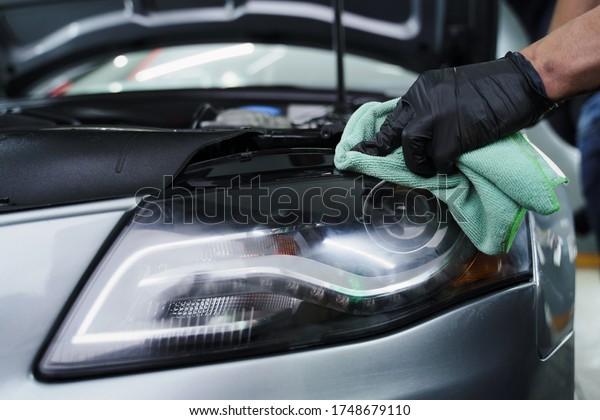 young man working on\
dry cleaning. car detailing. polishing. car wash. oil change in the\
car. car service