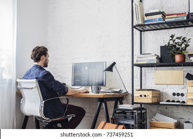 Young man working on his computer - Shutterstock ID 737459251