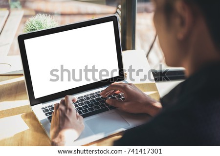 Young man working on his laptop with blank copy space screen for your advertising text message in office, Back view of business man hands busy using laptop at office desk