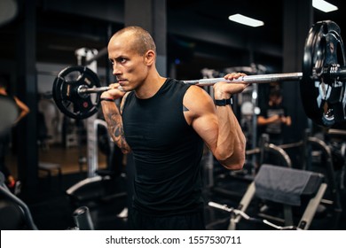 Young man working out with weights in the gym