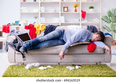 Young Man Working Studying In Messy Room