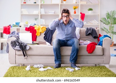 Young Man Working Studying In Messy Room