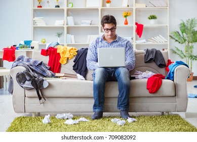 Young Man Working Studying In Messy Room