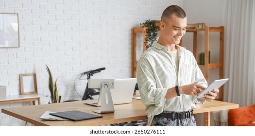 Young man working with tablet computer in office