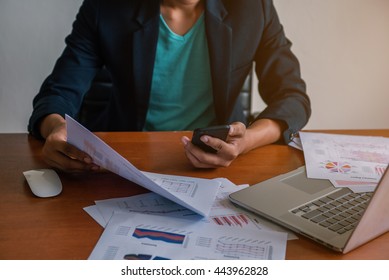 young man working using smartphone and notebook computer, Young man work and typing,financial work,workhard.