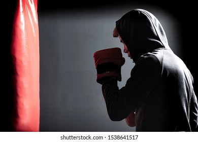 The young man workout a kick on the punching bag in gym - Powered by Shutterstock