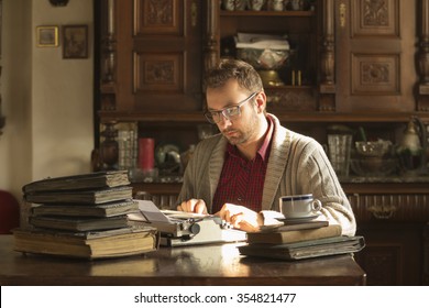 Young Man Writing On Old Typewriter.