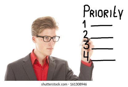 Young man writing priority items isolated on white background