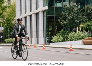 Young manager comuting to the office by electic scooter