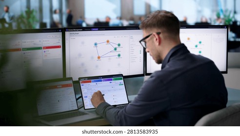 Young IT Manager Monitors User Access Approval Workflow On Cloud Dashboard.