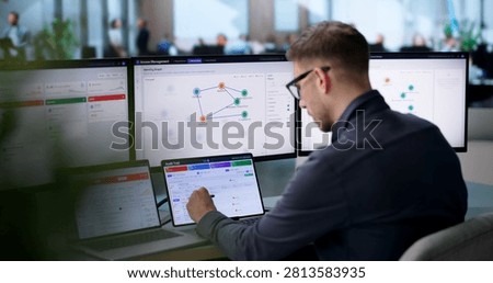 Young IT Manager Monitors User Access Approval Workflow On Cloud Dashboard.
