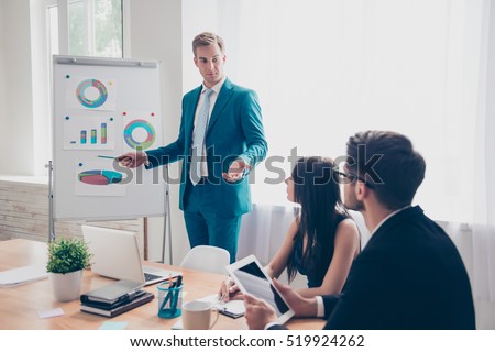 Young manager presenting whiteboard to his colleagues about financial growth