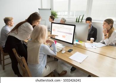 Young manager teaching senior worker explains planning work in office, corporate teacher helps older employee with application, aged woman using calendar on group computer training, mentoring concept - Shutterstock ID 1032426241