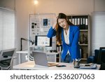 Young manager woman having a headache and feeling tired from overwork,she is stressed and has office syndrome from work