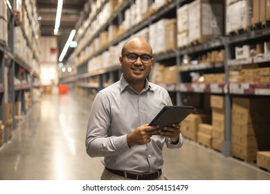 Young manager worker checklist manage parcel box product in warehouse. Asian supervisor man using tablet working at store industry. Logistic import export concept. - Shutterstock ID 2054151479