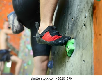 Young man's foot climbing indoor wall - Powered by Shutterstock