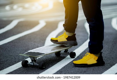 Young man's legs in sneakers on skateboard with sunset, Blurred background. - Powered by Shutterstock