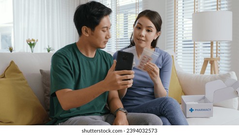 Young married asia people prepare pregnant plan checkup preconception consult at home sofa. Clinic app illness screen on online advice doctor remote exam telemedicine video call talk on tablet phone. - Powered by Shutterstock