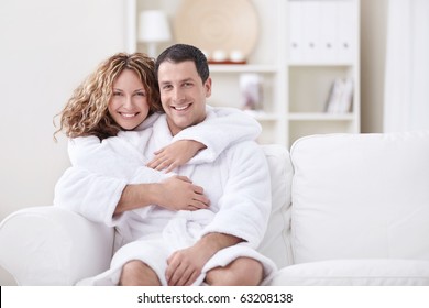 Young Married Couple In Dressing Gowns At Home