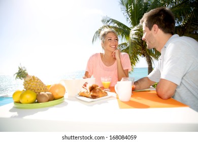 Young Married Couple Enjoying Breakfast In Luxury Hotel 