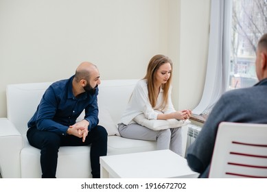 A Young Married Couple Of Men And Women Talk To A Psychologist At A Therapy Session. Psychology.