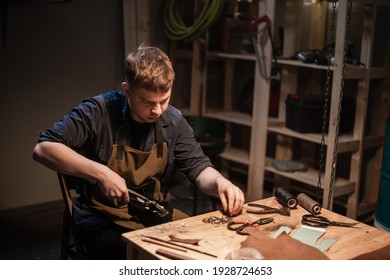 a young master in the manual production of shoes in his workshop is working on creating shoes - Powered by Shutterstock