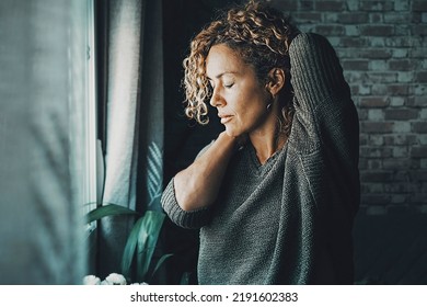 Young Mature Woman Touching His Neck For Backpain And Stretching Arms. Concept Of Healthy And Body Condition People Female Massaging His Back For Pain And Closing Eyes To Relax. Concept Of Bad Posture