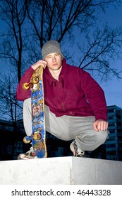 Young, Mean Looking Skate Boarder On A Concrete Ledge