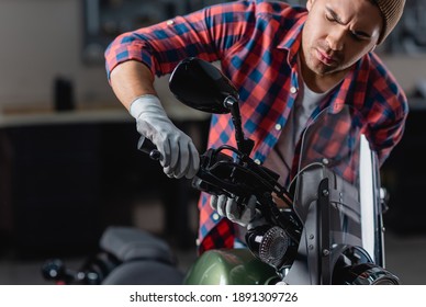 young mechanic checking brake handle on motorbike handlebar - Powered by Shutterstock