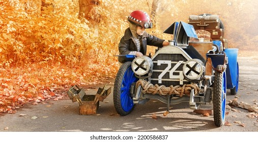 Young Mechanic Repairs An Old Race Car In An Autumn Park