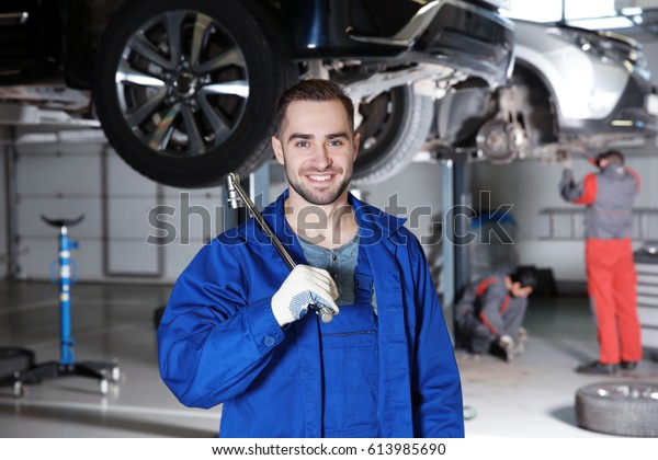 Young mechanic with\
tool in car service