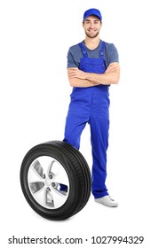 Young Mechanic In Uniform With Car Tire On White Background