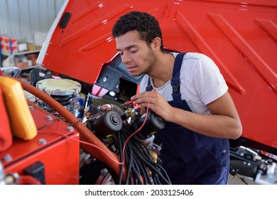 A Young Mechanic Using Multimeter